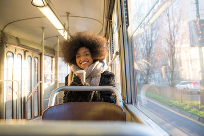 Portrait of woman sitting in train