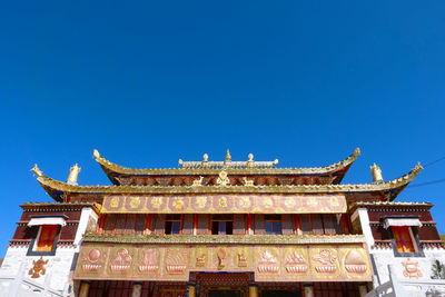 Low angle view of building against blue sky