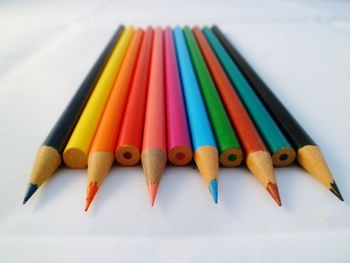 Close-up of colored pencils on white background