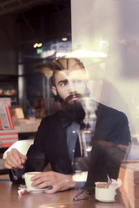 Hipster businessman on break for a coffee