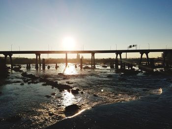 View of bridge over river against clear sky