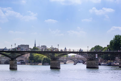 View of pont des arts bridge over river seine with background of pont neuf bridge and cite island