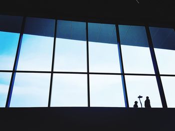 Low angle view of silhouette people against sky