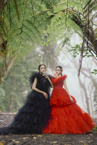 Portrait of young woman standing in forest