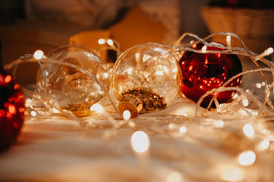 Abstract christmas and new year tree decor in red and gold colors close-up, with garlands and lights