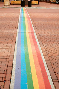 Multi colored umbrella on sidewalk