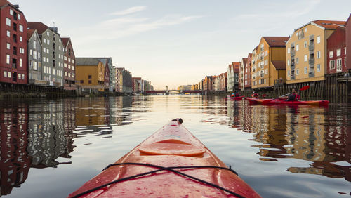 Canal amidst buildings in city against sky