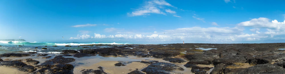 Panoramic view of beach against blue sky