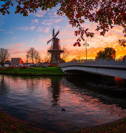 Bridge over river against sky during sunset