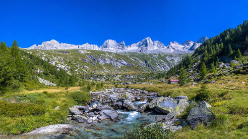 Scenic view of mountain against blue sky