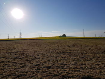 Surface level of electricity pylon on land against sky