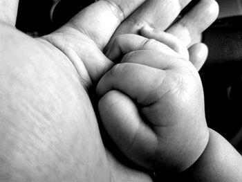 Close-up of baby holding hands