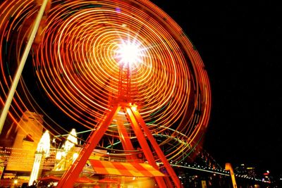 Low angle view of illuminated ferris wheel