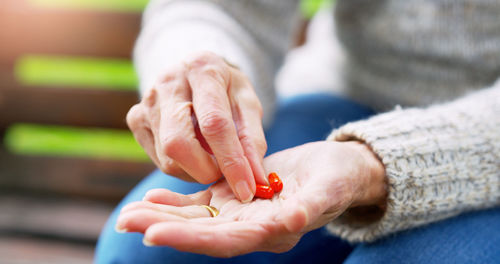 Cropped hand of woman holding baby