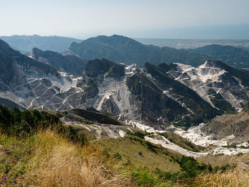 View of the carrara marble quarries and the transport trails carved into the side of the mountain.