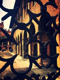 Close-up of metal fence against building