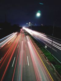 High angle view of light trails on highway at night