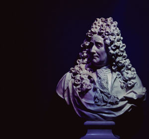 Low angle view of statue against black background