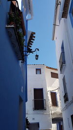 Low angle view of residential buildings against blue sky