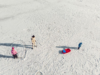 High angle view of people playing on sand at beach