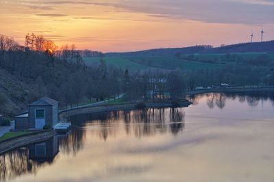 Scenic view of river against sky during sunset