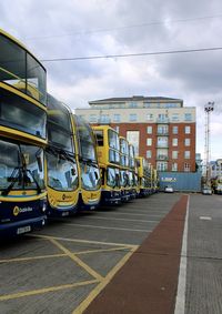 Cars on road against sky in city