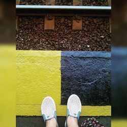 Low section of people standing on tiled floor