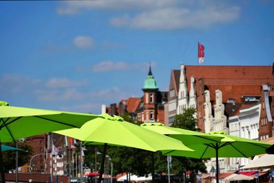 Buildings in city against blue sky