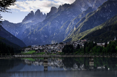 Scenic view of lake by mountains against sky