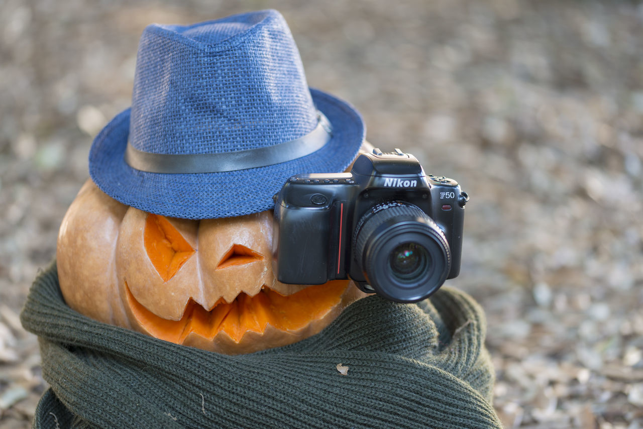 CLOSE-UP OF MAN PHOTOGRAPHING CAMERA ON MIRROR