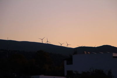 Silhouette of traditional windmill against clear sky
