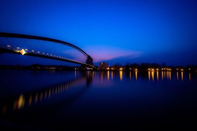 Three countries bridge over rhine river against blue sky at dusk