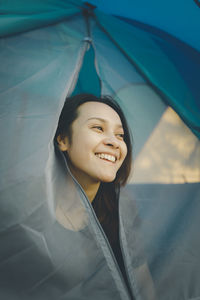 Portrait of young woman holding umbrella