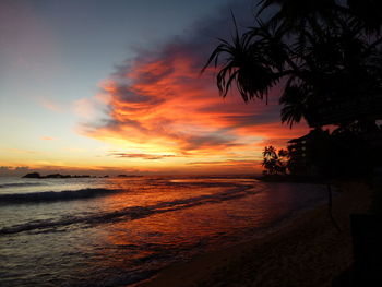 Scenic view of sea against orange sky