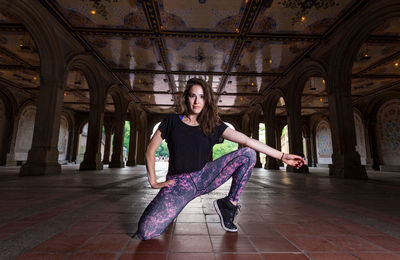 Side view of woman dancing on tiled floor