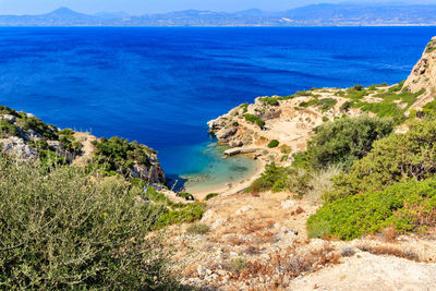 A beautiful view from a steep rocky slope on the corinthian gulf and the blue lagoon on the coast.