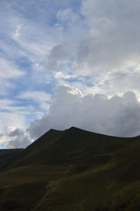 Scenic view of mountains against cloudy sky