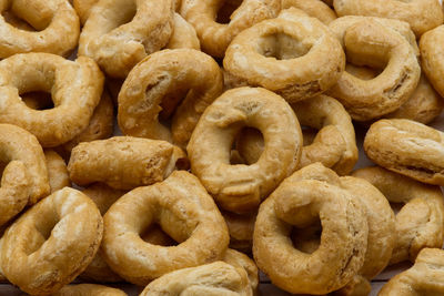 Taralli alla pugliese with extra virgin olive oil background. traditional italian snack taralli