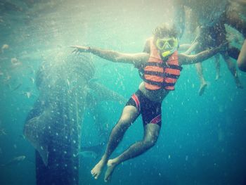 Young woman snorkeling undersea