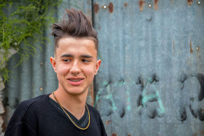 Portrait of a smiling young man standing outdoors