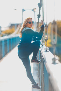 Young woman in sunglasses against clear sky