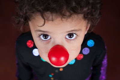 Portrait of boy wearing clown nose