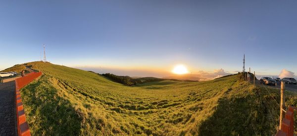 Scenic view of field against sky during sunset