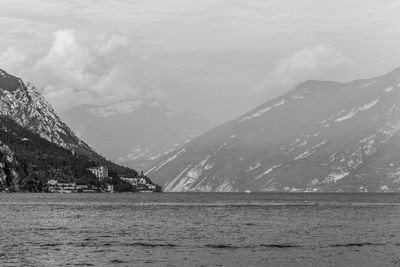 Scenic view of snowcapped mountains by sea against sky