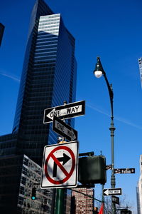 Low angle view of street light against blue sky