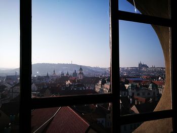 Cityscape against clear sky seen through window