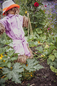 Rear view of girl standing by plants