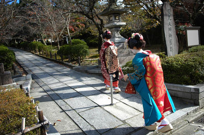 Women wearing in traditional clothing walking on road