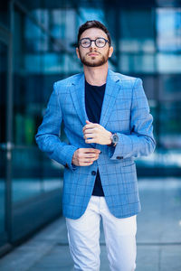 Portrait of young man standing outdoors
