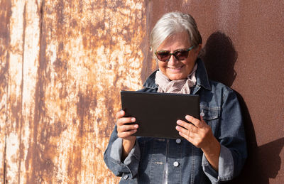 Mid adult woman using mobile phone